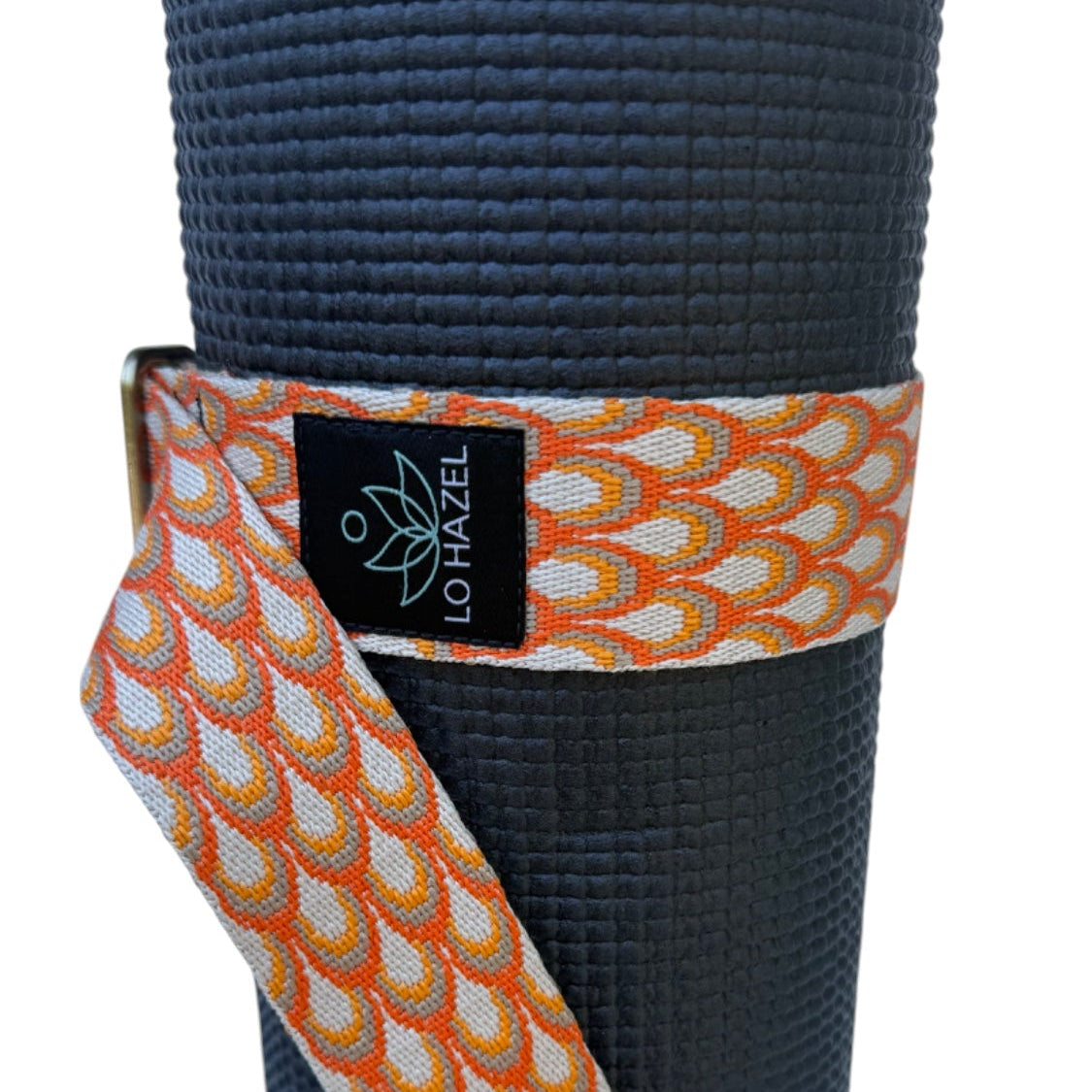 Yoga mat with a patterned strap and Lo Hazel logo on a white background
